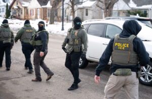 Federal agents leave a scene after one of their vehicles got a flat tire on Penn Avenue on February 5, in Minneapolis. Stephen Maturen/Getty Images